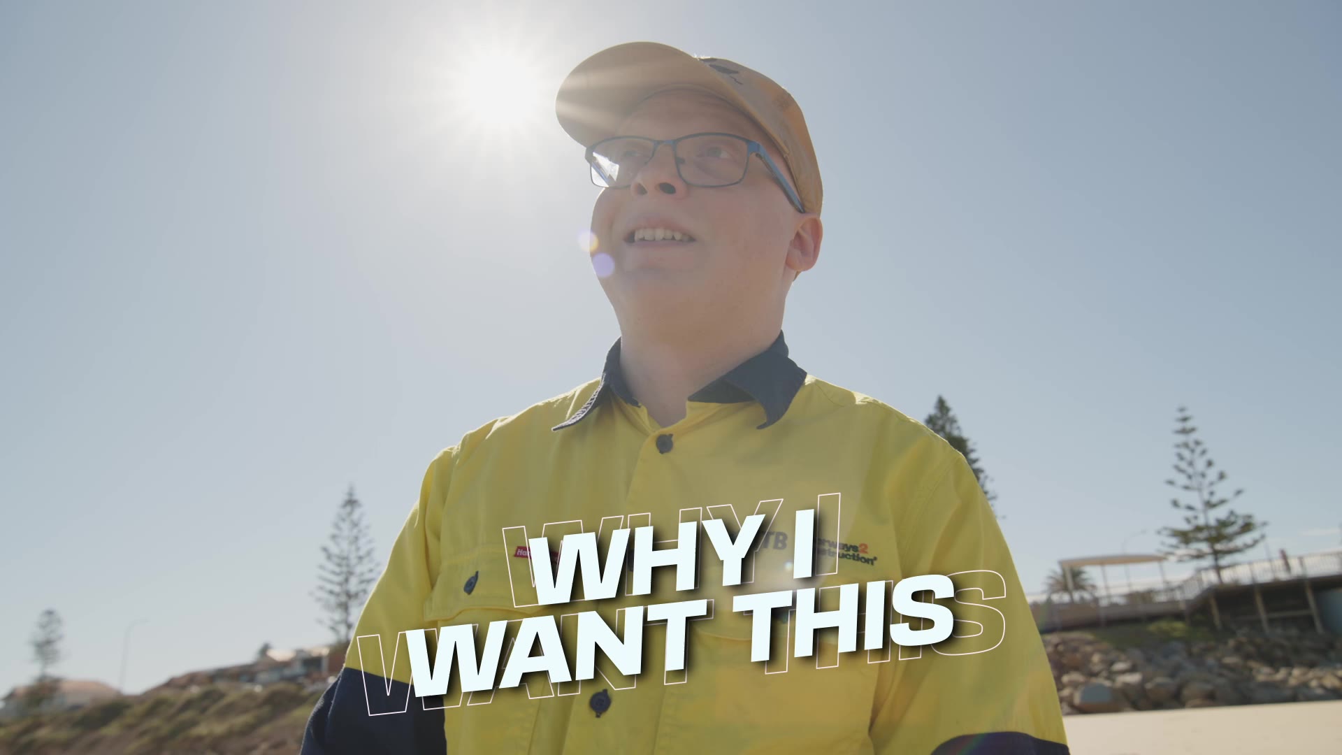Keagan in hi-vis at the beach talking about what he would bring to a team